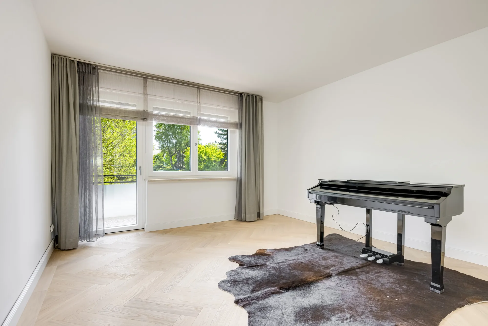 Musikzimmer mit Flügel und Blick auf die Terrasse