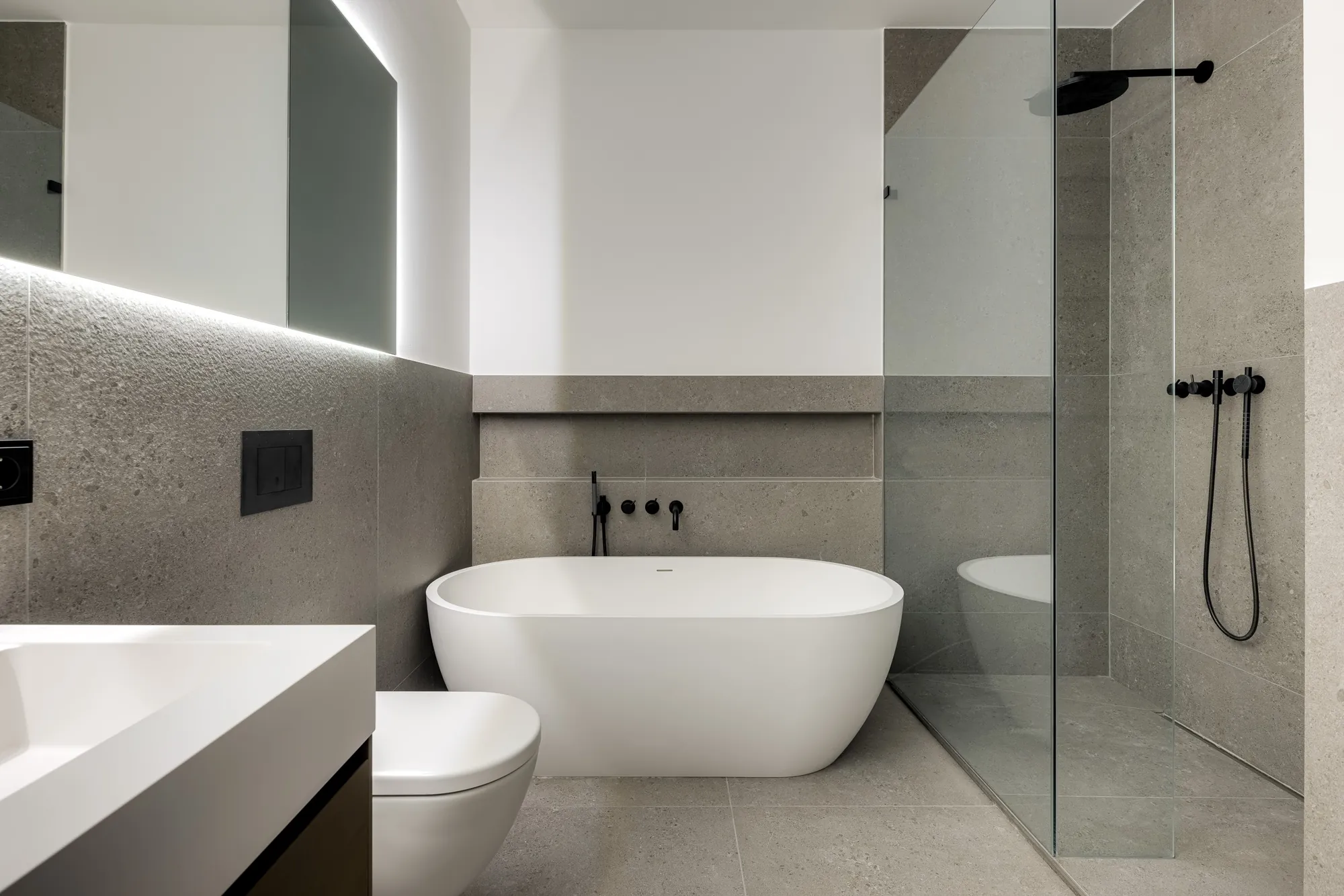 Freistehende Wanne neben der Glasdusche